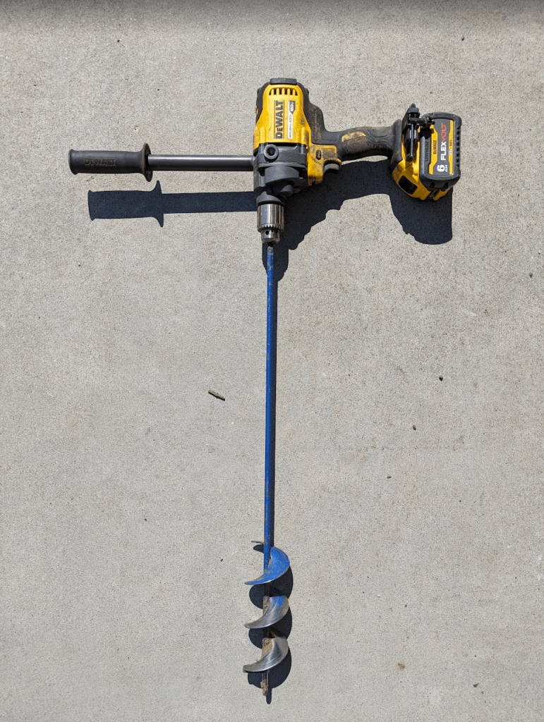 A cordless mixing drill with a 3 by 36 inch suger bit perfect for quick installation of hundreds and thousands of native plant plugs in a garden.